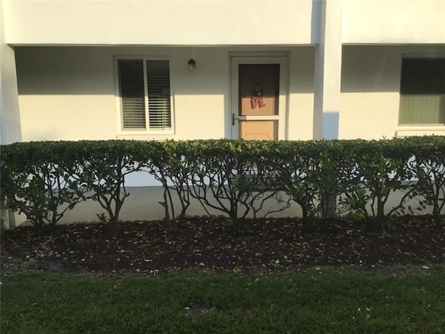 property entrance with stucco siding