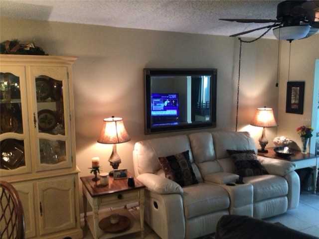 living room with a textured ceiling and ceiling fan