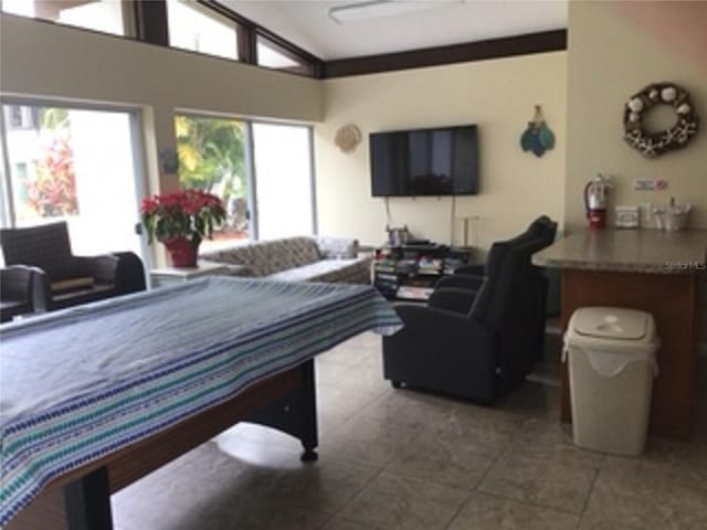 game room featuring tile patterned flooring and lofted ceiling