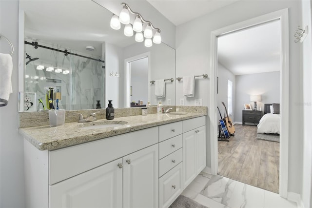 bathroom with vanity and a shower with shower door