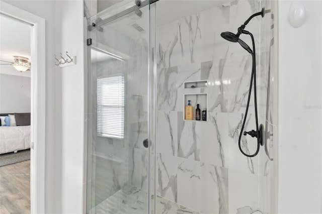 bathroom with hardwood / wood-style flooring and walk in shower