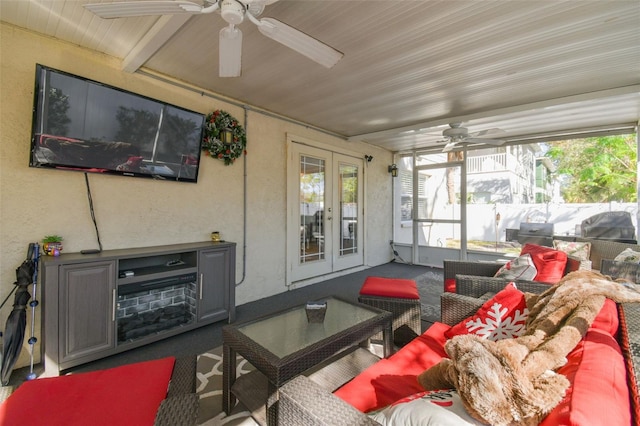 sunroom / solarium with ceiling fan and french doors