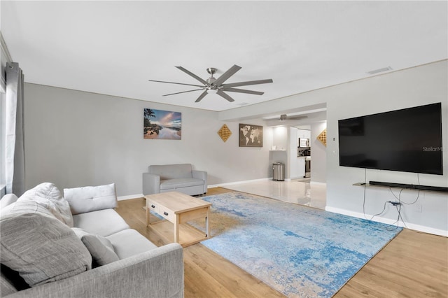 living room featuring wood-type flooring and ceiling fan