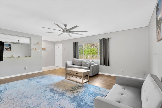 living room with wood-type flooring and ceiling fan