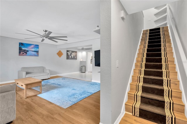 living room featuring ceiling fan and wood-type flooring