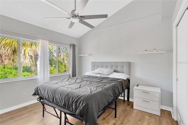 bedroom with lofted ceiling, light hardwood / wood-style flooring, and ceiling fan