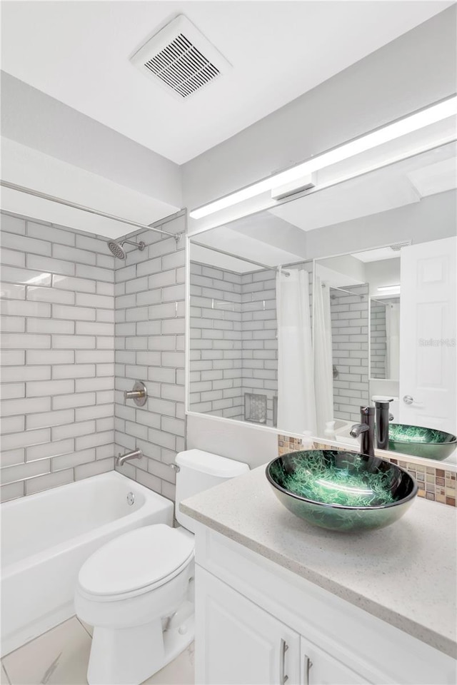 full bathroom featuring vanity, toilet, and shower / bath combo with shower curtain