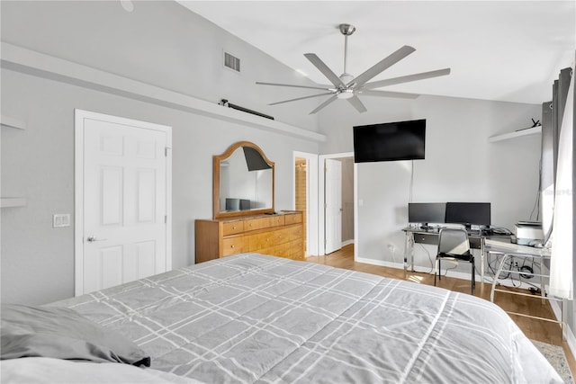 bedroom with hardwood / wood-style flooring, vaulted ceiling, and ceiling fan