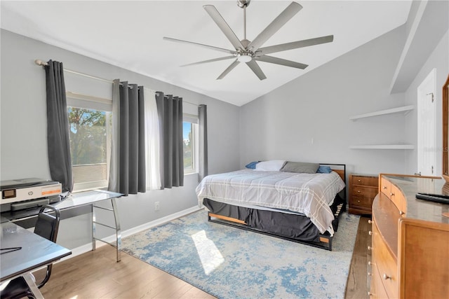 bedroom with light hardwood / wood-style flooring, ceiling fan, and vaulted ceiling