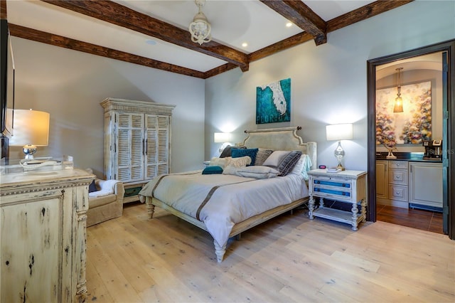 bedroom featuring light hardwood / wood-style flooring and beamed ceiling