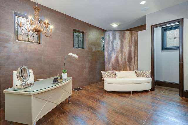 interior space featuring tile walls and an inviting chandelier