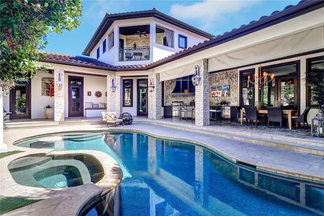 view of swimming pool with an in ground hot tub, ceiling fan, and a patio