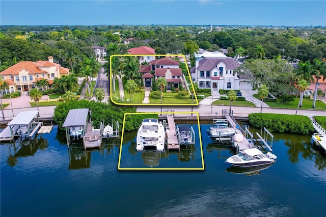 drone / aerial view featuring a residential view and a water view