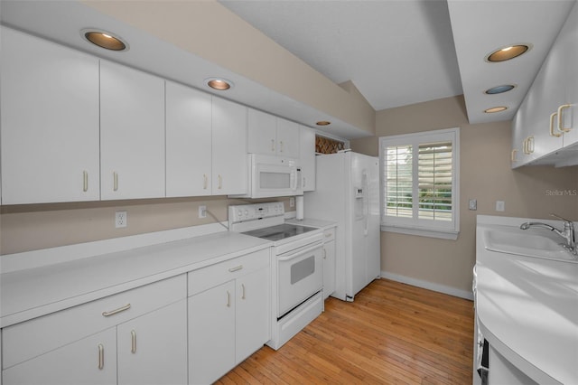 kitchen featuring white appliances, light hardwood / wood-style floors, sink, and white cabinets