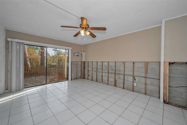 unfurnished room with ceiling fan, a textured ceiling, and light tile patterned floors