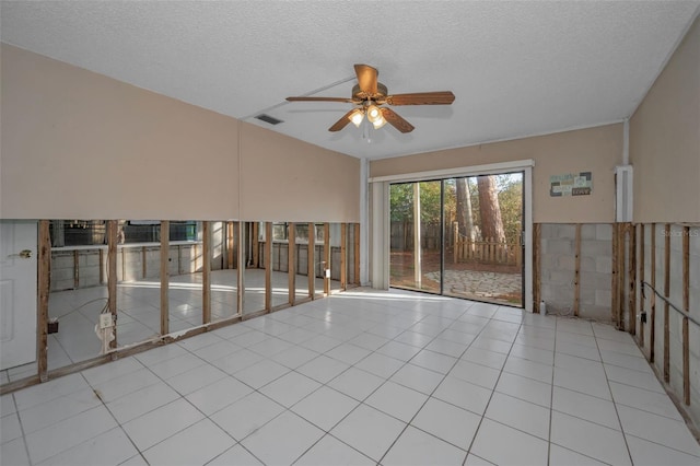 empty room featuring light tile patterned flooring, ceiling fan, and a textured ceiling