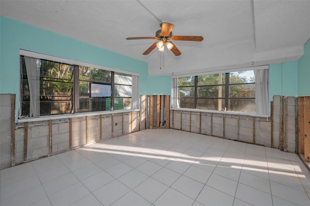 tiled empty room featuring ceiling fan