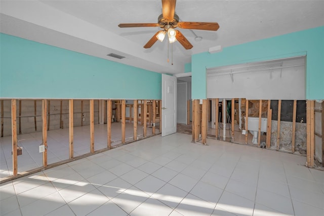 tiled spare room with ceiling fan