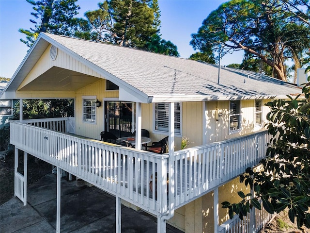 rear view of house featuring a deck