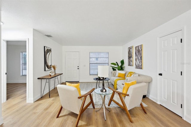 living area with plenty of natural light and light wood-type flooring