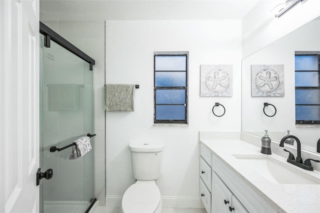 bathroom featuring walk in shower, vanity, and toilet