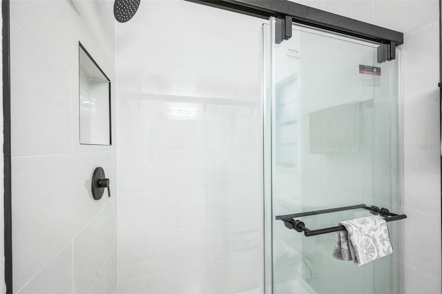 bathroom featuring a shower with door