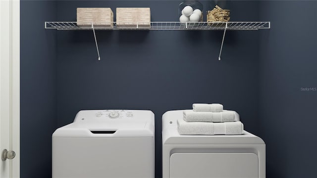 washroom with washing machine and clothes dryer