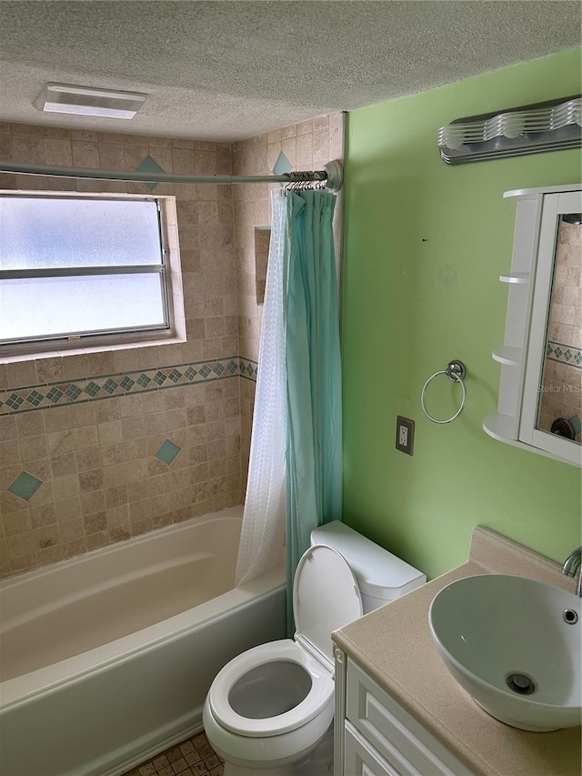 full bathroom featuring shower / bathtub combination with curtain, vanity, toilet, and a textured ceiling