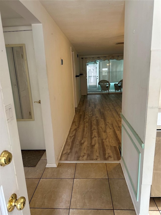 hallway featuring tile patterned flooring