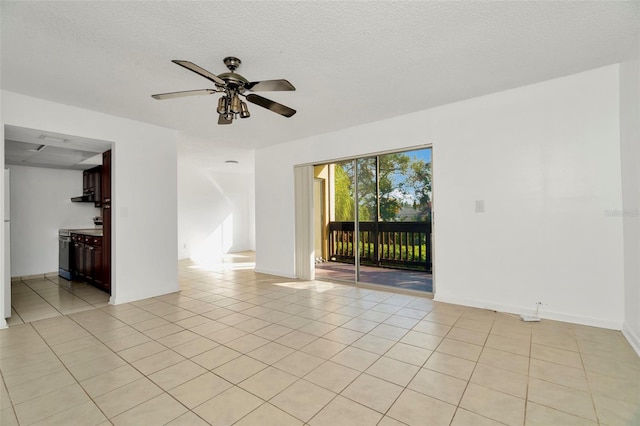 spare room with light tile patterned flooring, a textured ceiling, and ceiling fan