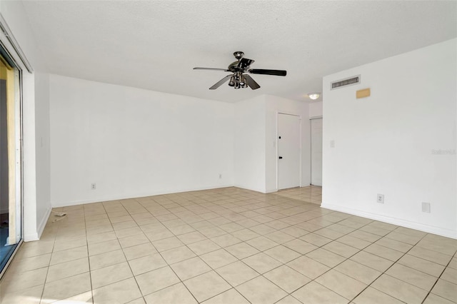 spare room with a textured ceiling and ceiling fan