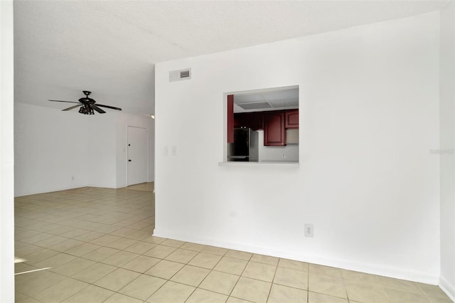 tiled empty room with ceiling fan