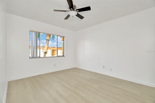 unfurnished room featuring ceiling fan, light hardwood / wood-style floors, and a textured ceiling