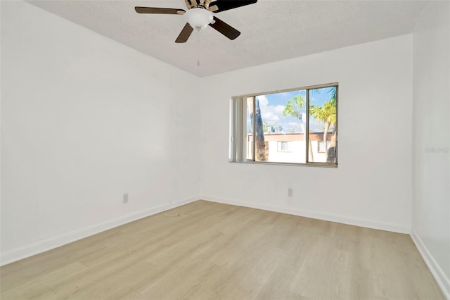 spare room featuring ceiling fan, a textured ceiling, and light hardwood / wood-style floors