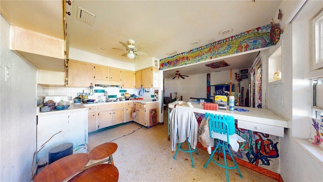 kitchen featuring ceiling fan, sink, and decorative backsplash