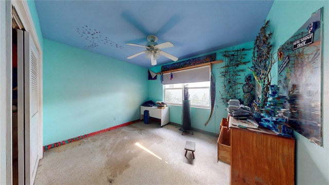 unfurnished bedroom with ceiling fan and carpet