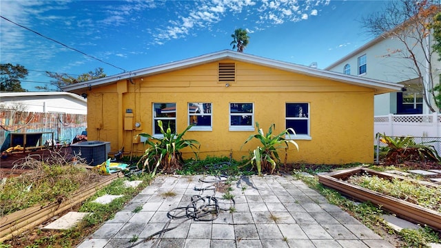 back of property featuring central AC unit and a patio area