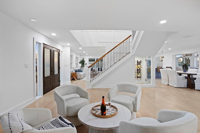 living room featuring french doors and light hardwood / wood-style floors