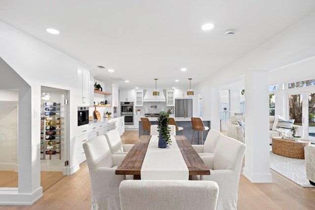 dining space featuring light wood-type flooring