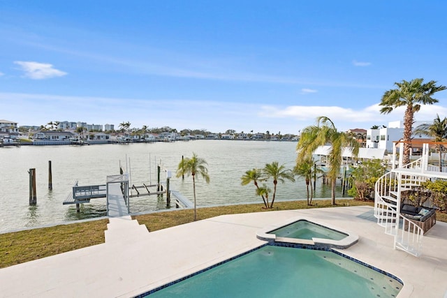 view of pool featuring an in ground hot tub, a water view, a dock, and a patio