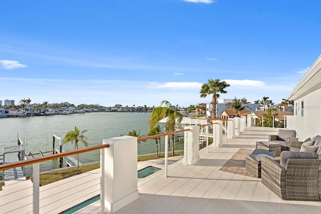 view of patio featuring a water view, an outdoor hangout area, and a boat dock