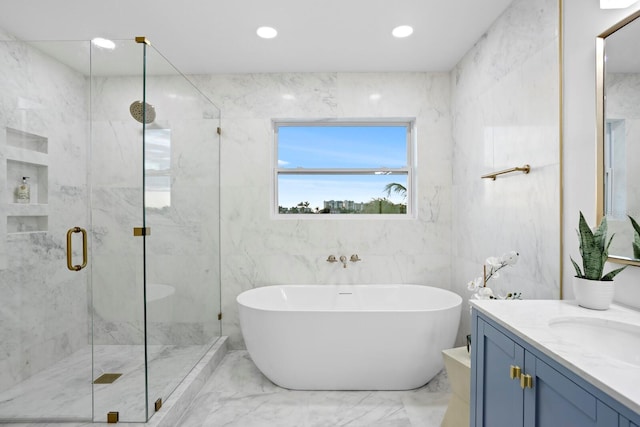 bathroom featuring vanity and shower with separate bathtub