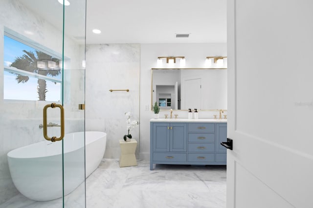 bathroom featuring vanity and a washtub