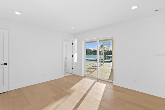 unfurnished room with light hardwood / wood-style flooring