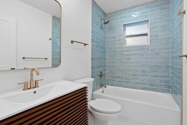 full bathroom featuring tiled shower / bath combo, vanity, and toilet