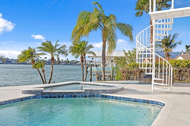 view of swimming pool featuring a patio area and a water view