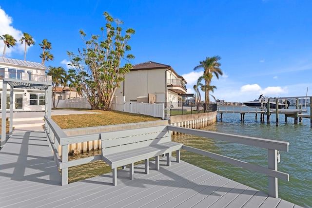 view of dock with a water view and a yard