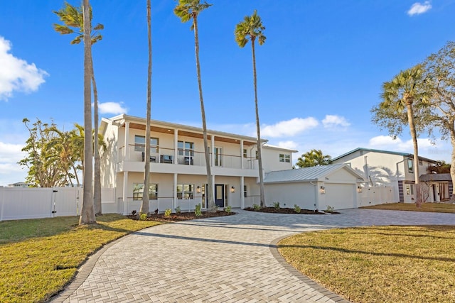 view of front of property with a front lawn and a balcony