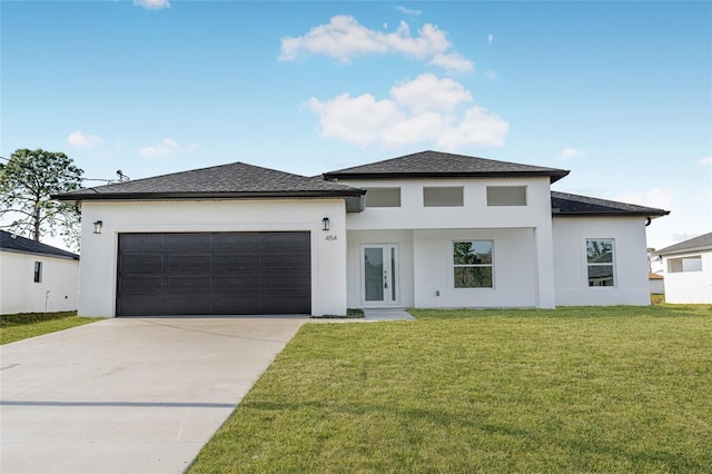 prairie-style house featuring a garage and a front yard