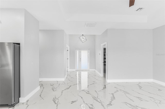 entrance foyer with a raised ceiling